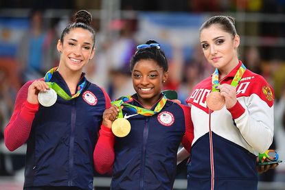 Gymasts Aly Raisman, Simone Biles, and Aliya Mustafina wear their Olympic medals in Rio