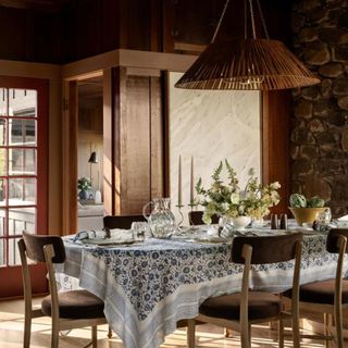 A wicker light fixture in a dining room designed by McGee & Co.