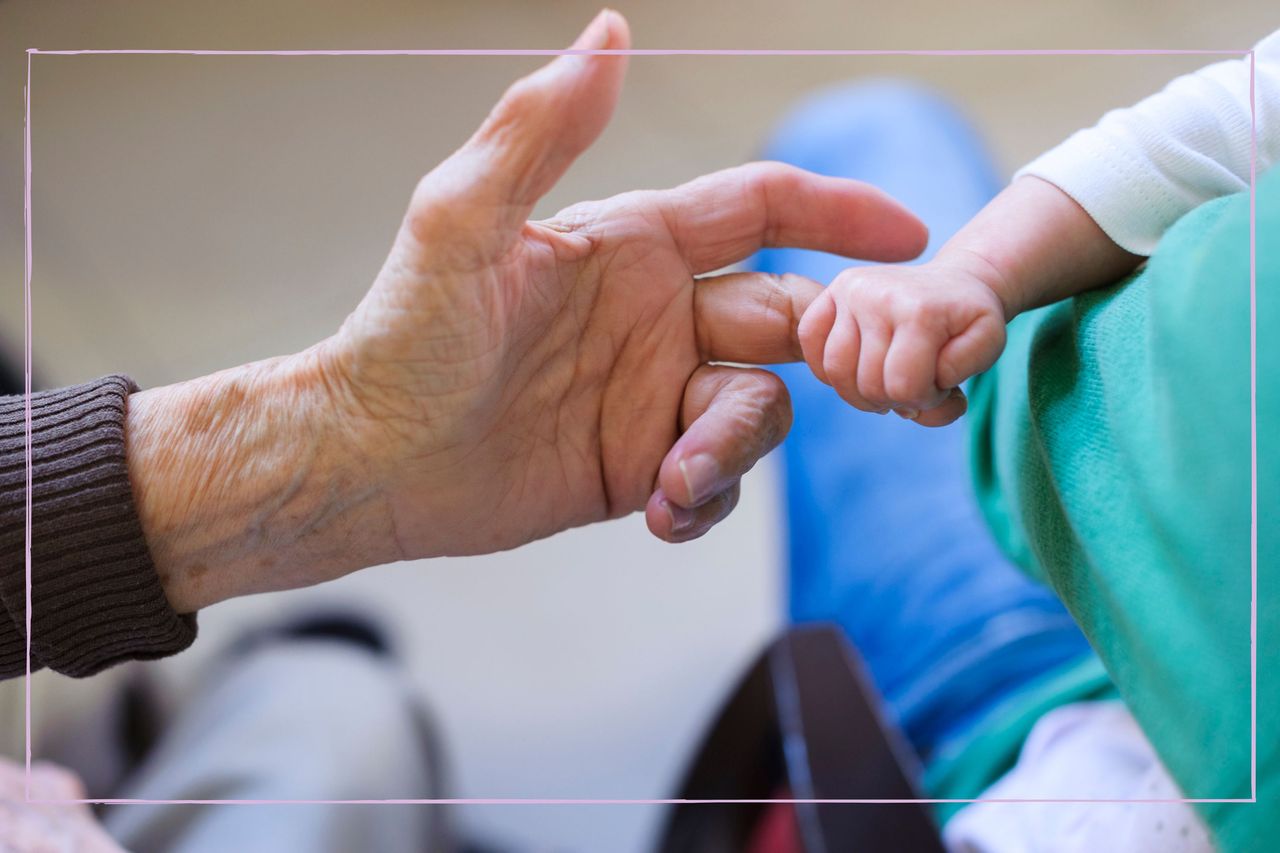 Grandparent holding baby&#039;s finger