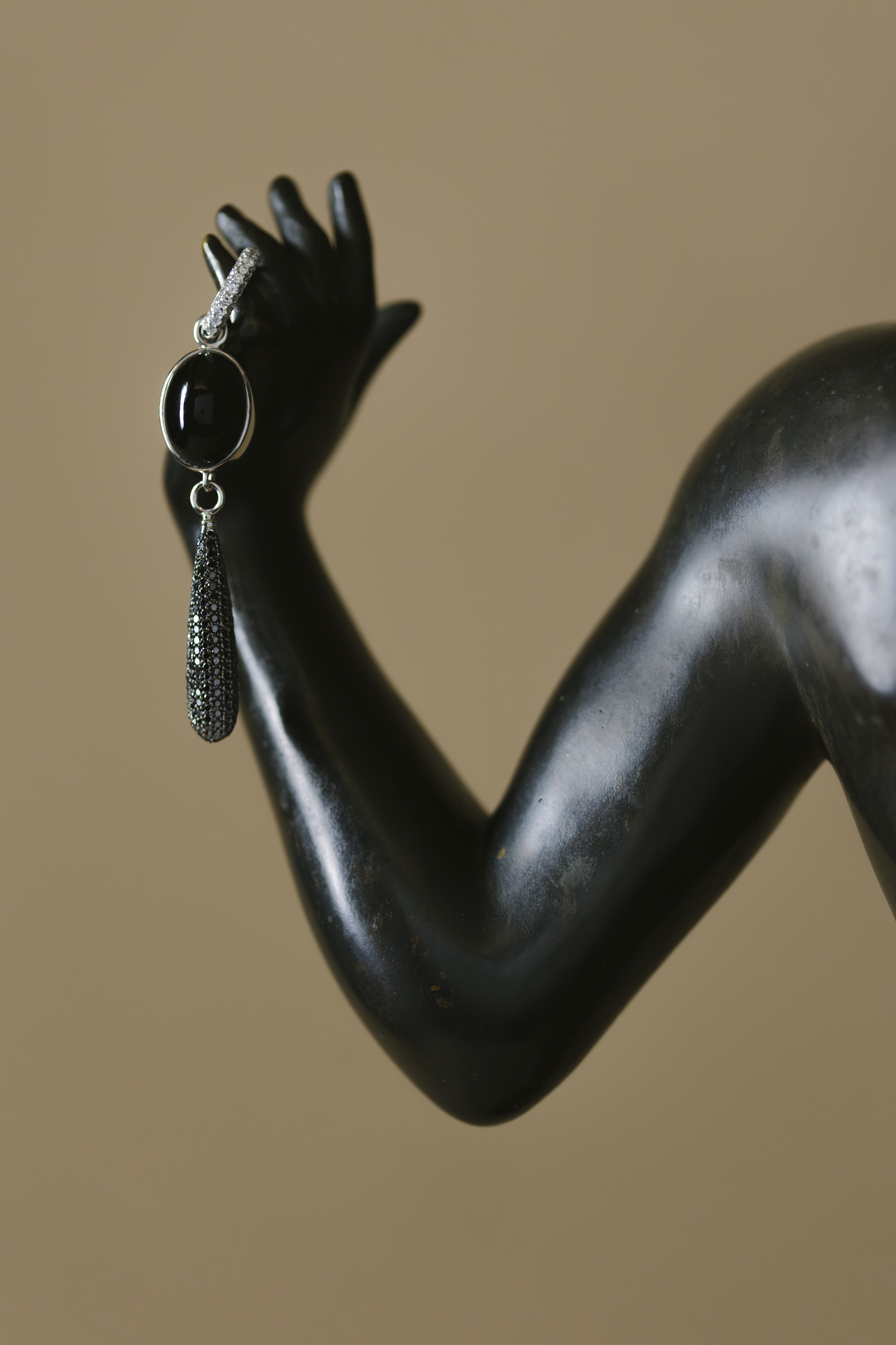 ceramics and jewellery against green and brown backgrounds