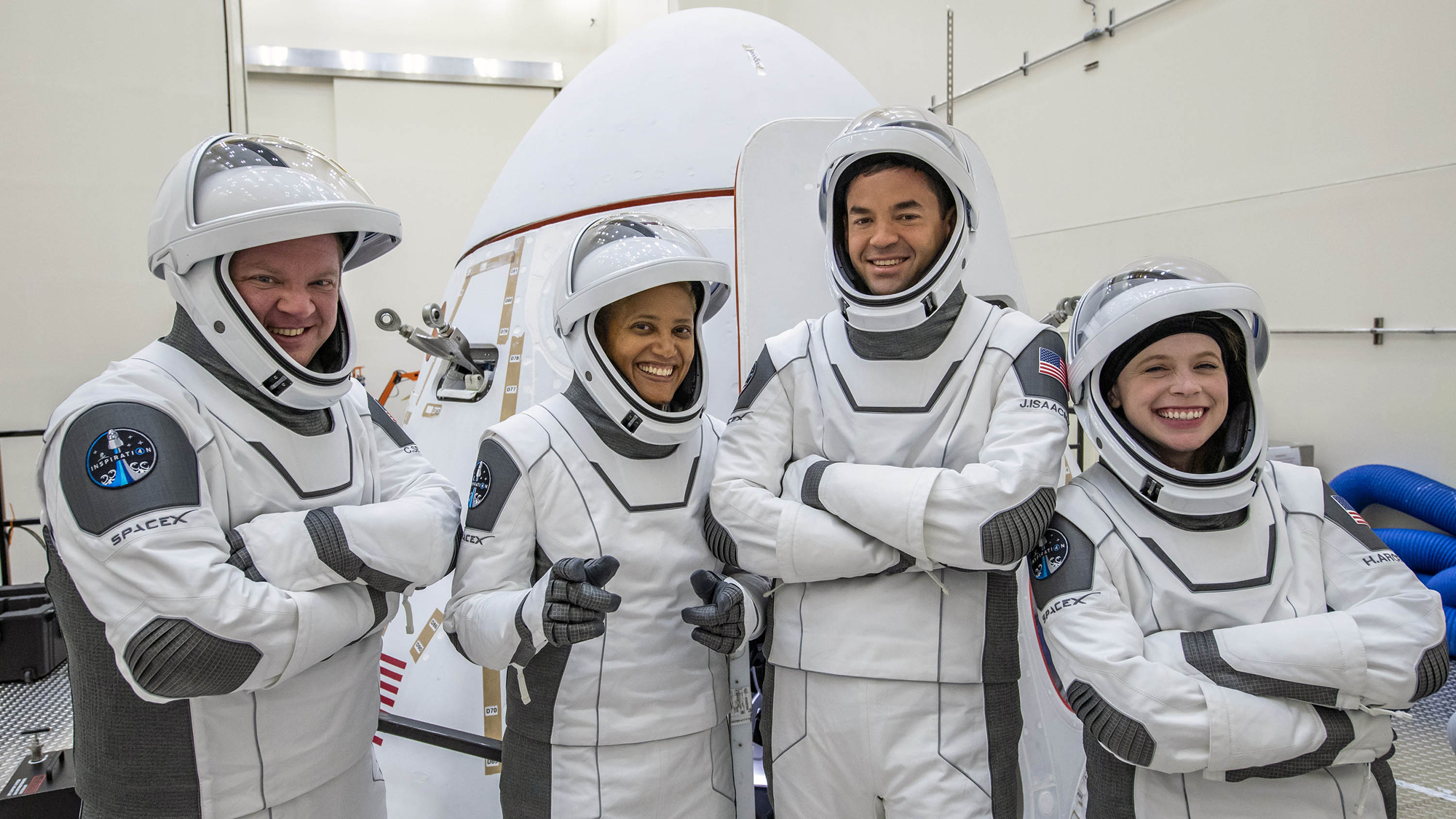 The Inspiration4 crew pose with their Crew Dragon spacecraft.