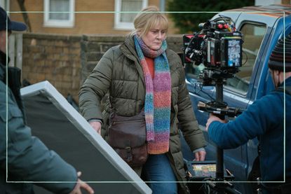 a close up of Sarah Lancashire filming Happy Valley with camermen around her