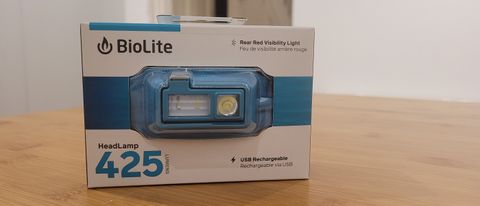 The Biolite HeadLamp 425 in its packaging placed on a wooden table
