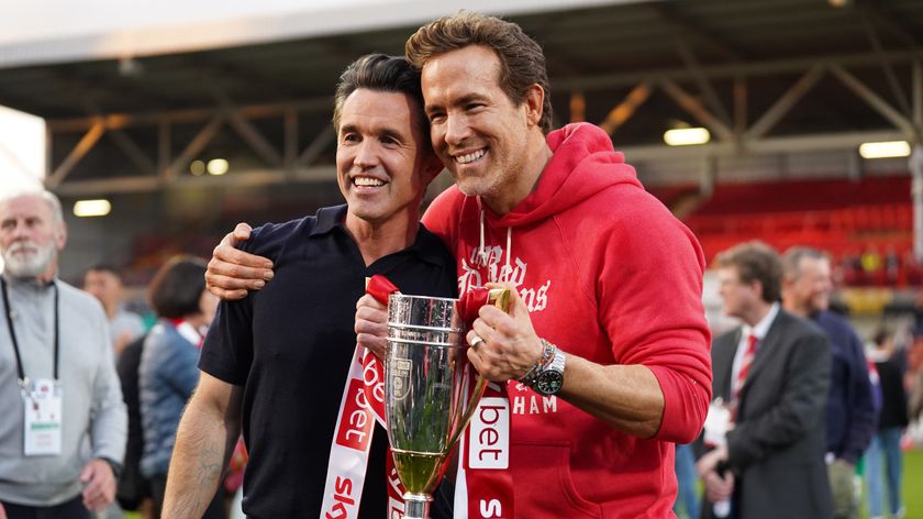 Rob McElhenney and Ryan Reynolds, co-owners of Wrexham AFC, pose for a photo with the trophy following the club&#039;s promotion to the Sky Bet Championship during the Sky Bet League One match between Wrexham AFC and Charlton Athletic FC at Racecourse Ground on April 26, 2025 in Wrexham, Wales. 