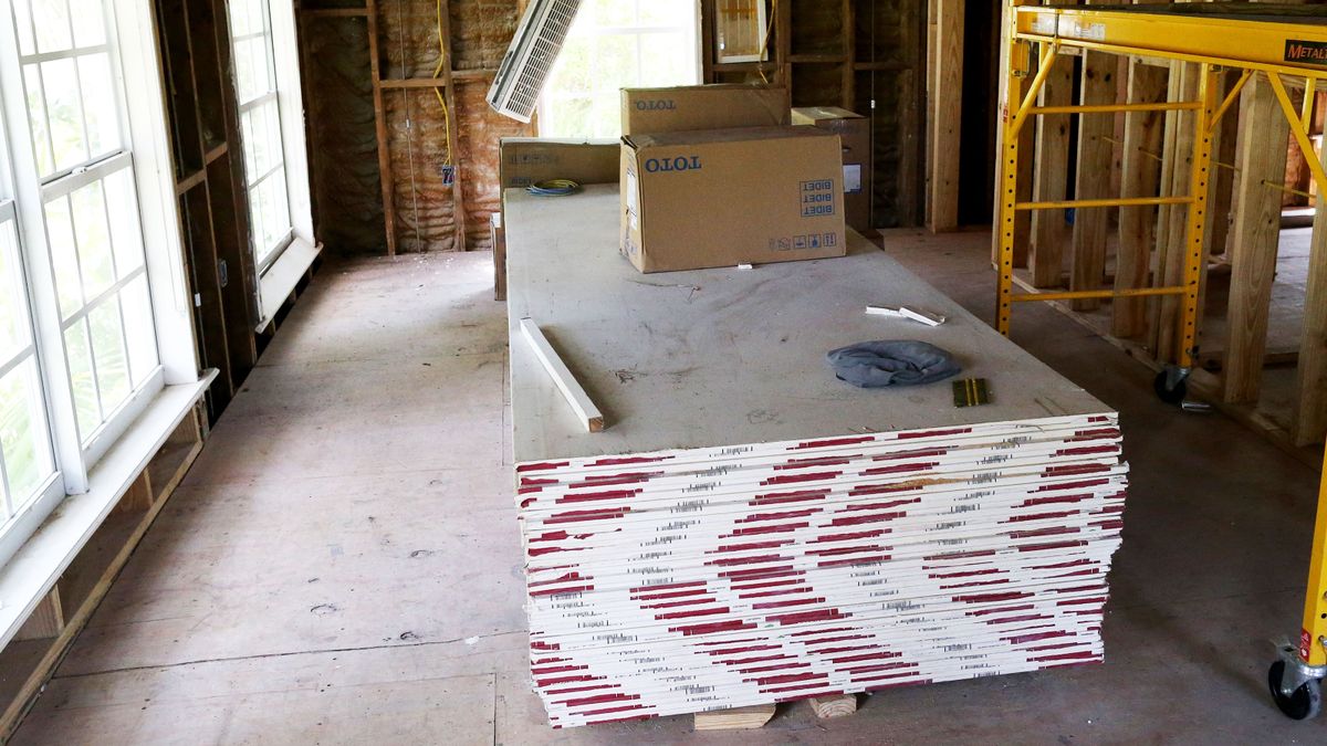 Pile of plasterboard sheets on construction site