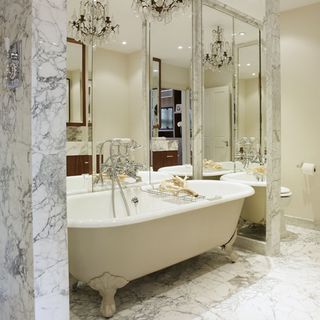 White bath and marble walls
