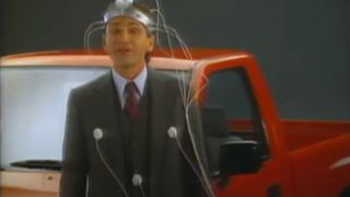 David Leisure stands hooked up to a lie detector in front of a truck for Isuzu.