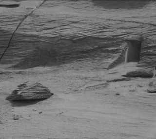 A black and white image of what appears to be a doorway in rock