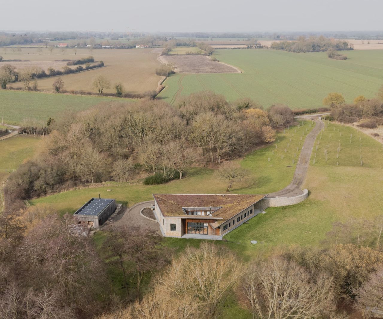 An overhead shot of a self build inverted house in a field