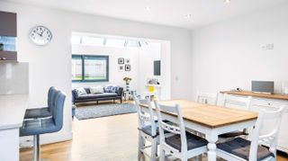 white painted dining room with view to living room extension
