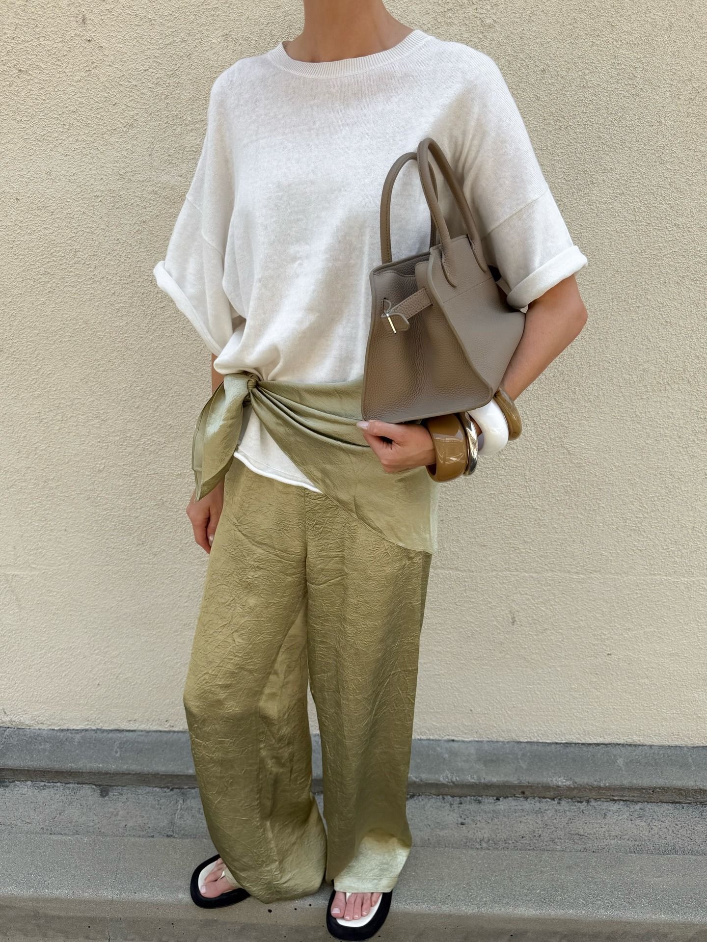 Elsa Hosk wears satin pants fall trend outfit.