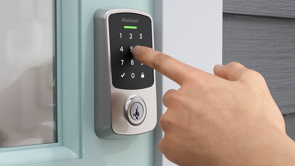 Person punching code into Kwikset Aura Reach Smart Lock