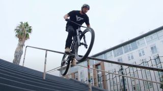 Dylan Stark pedal grinding down a staircase railing