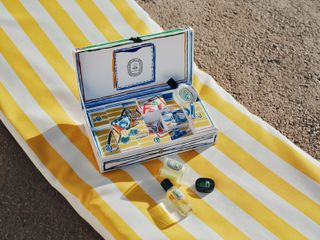 Diptyque summer collection fragrances laid out on a towel