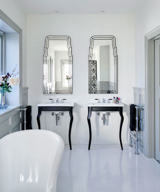 White bathroom with two vanities and matching mirrors