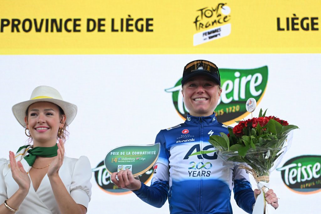 LIEGE BELGIUM AUGUST 14 Justine Ghekiere of Belgium and AG Insurance Soudal Team celebrates at podium as most combative rider prize winner during the 3rd Tour de France Femmes 2024 Stage 4 a 1227km stage from Valkenburg to Liege UCIWWT on August 14 2024 in Liege Belgium Photo by Dario BelingheriGetty Images