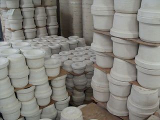 ceramic casts stacked in piles, awaiting firing