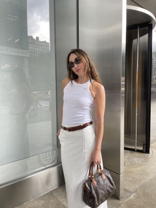 Senior Editor Anna LaPlaca wearing a Toteme white and maxi skirt.