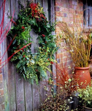 wreath hung on a door made from natural materials in a winter garden