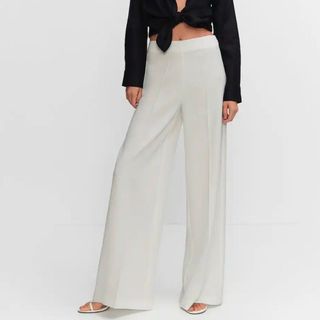 Mango High-waist palazzo trousers, on model with black crop top 