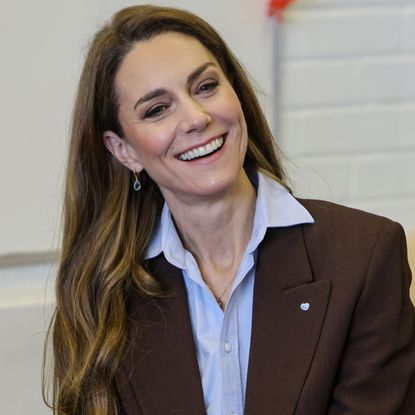 Princess Kate wearing a brown blazer and smiling
