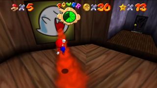 Super Mario 64: Big Boo's Haunt. Mario jumping over flame from Boo painting.