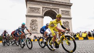 2025 Tour de France yellow jersey winner Tadej Pogacar leads the peloton through Paris in front of the Arc de Triomphe during the final stage/