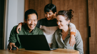 Three people looking at a computer screen