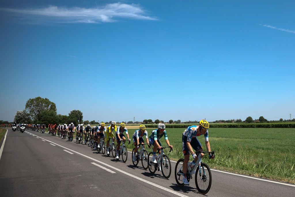 The pack of riders (peloton) cycles during the 2nd stage of the 111th edition of the Tour de France cycling race, 199 km between Cesenatico and Bologna, in Italy, on June 30, 2024. (Photo by Anne-Christine POUJOULAT / AFP)