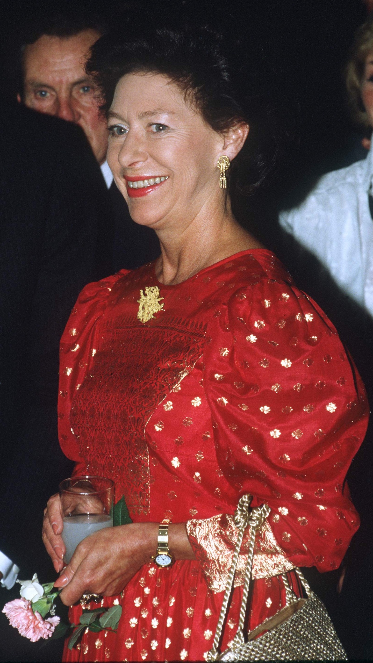 Princess Margaret holding a tall glass during her visit to the Royal Festival Hall in 1985