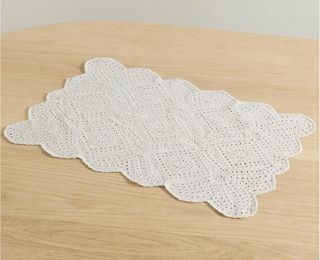 Scalloped lace detail placemat from Net-a-Porter.