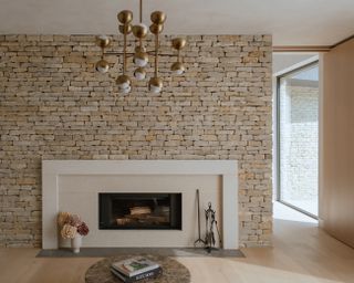 capability house with minimalist interiors of stone and timber and a twisting metal staircase