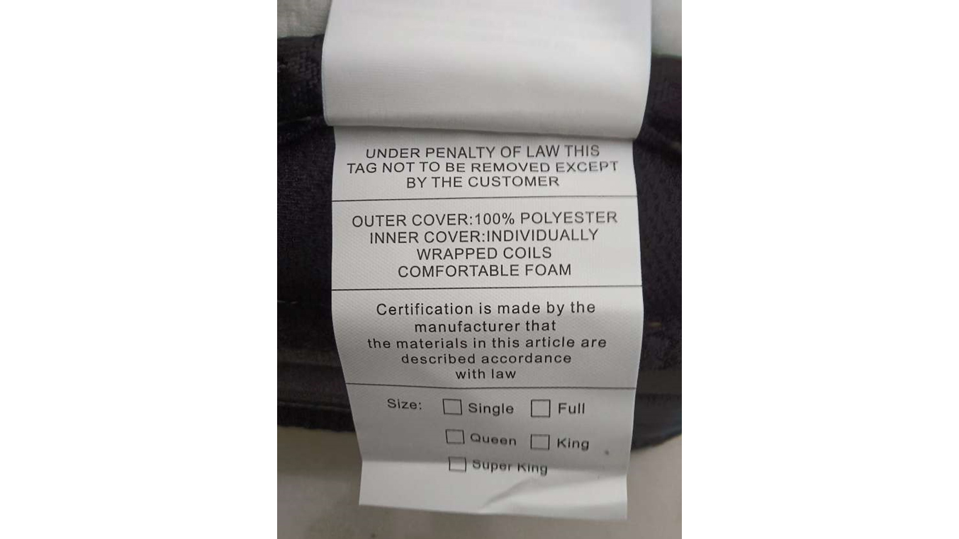 A white label on the side of a Crayan mattress. The label has information about the content and size of the mattress
