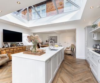 A glazed roof kitchen extension with large kitchen island and parquet flooring