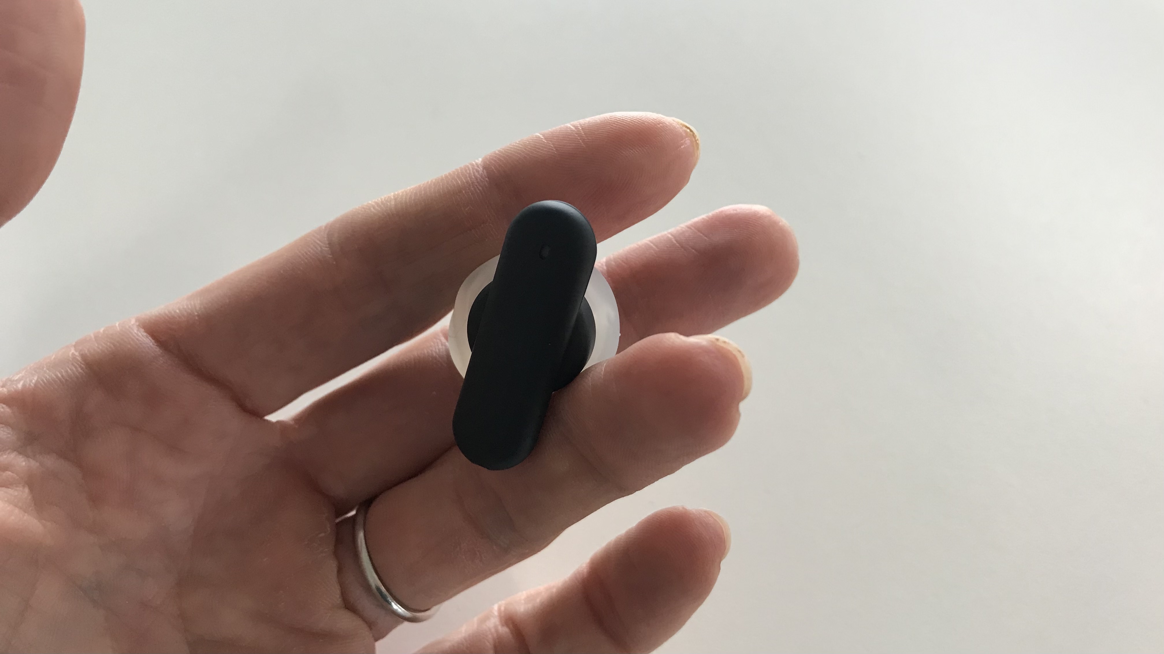UE Fits earbud held in a hand
