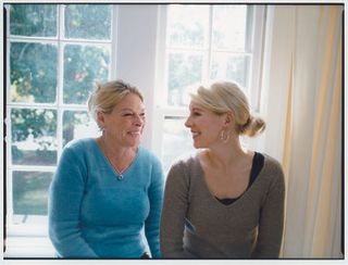 younger woman and older woman smiling at each other