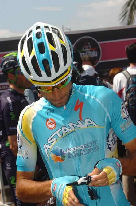 Vicenzo Nibali fidgets with a gadget before the start