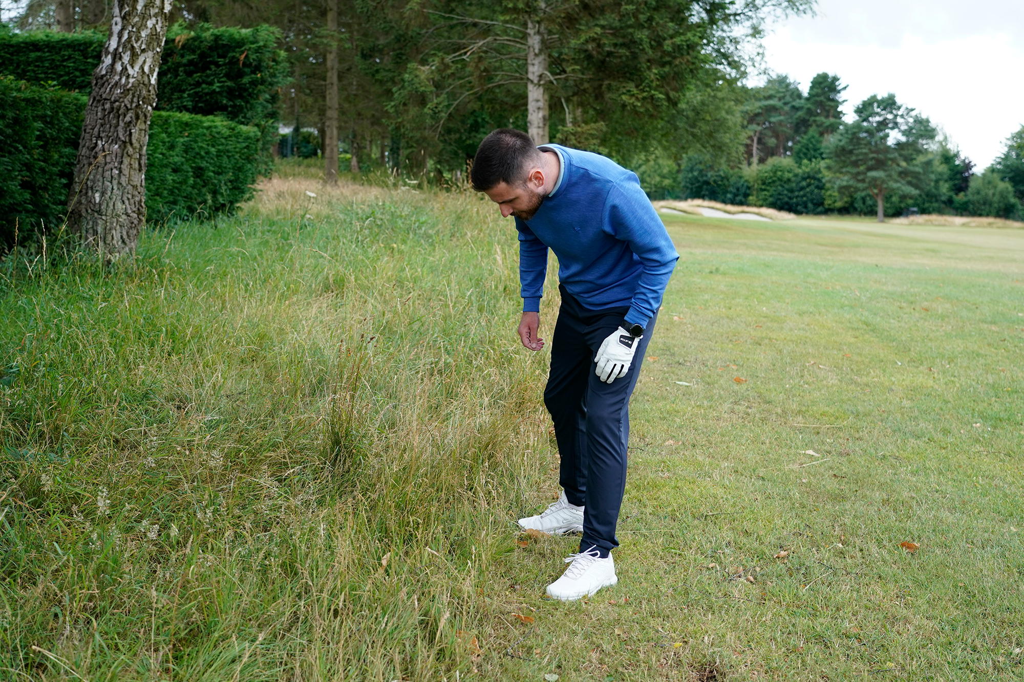 Baz Plummer searching for his golf ball in long grass down the left side of the second fairway at Sand Moor Golf Club