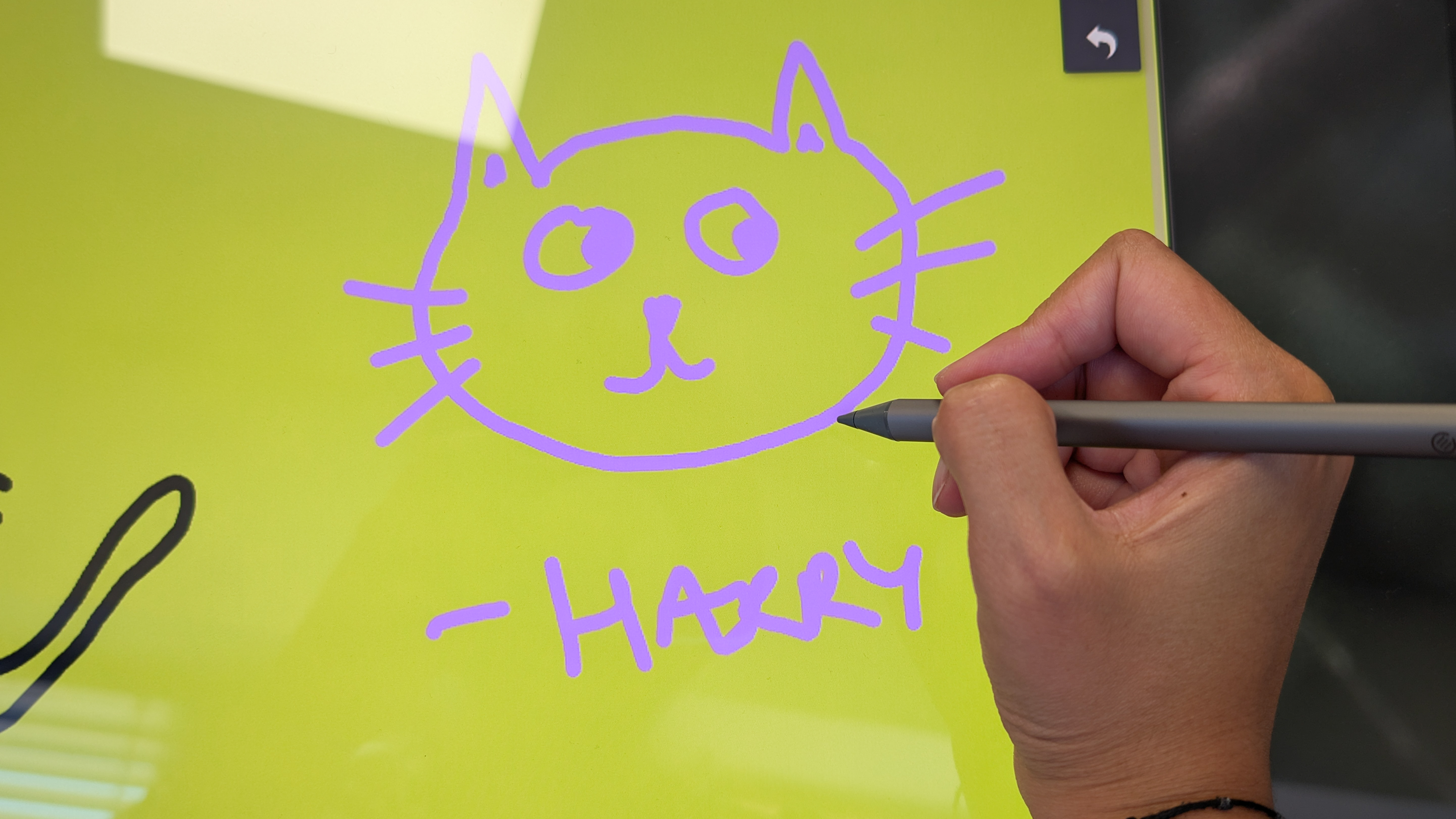 A stylus being used with an Alogic Clarity 6K Touch monitor