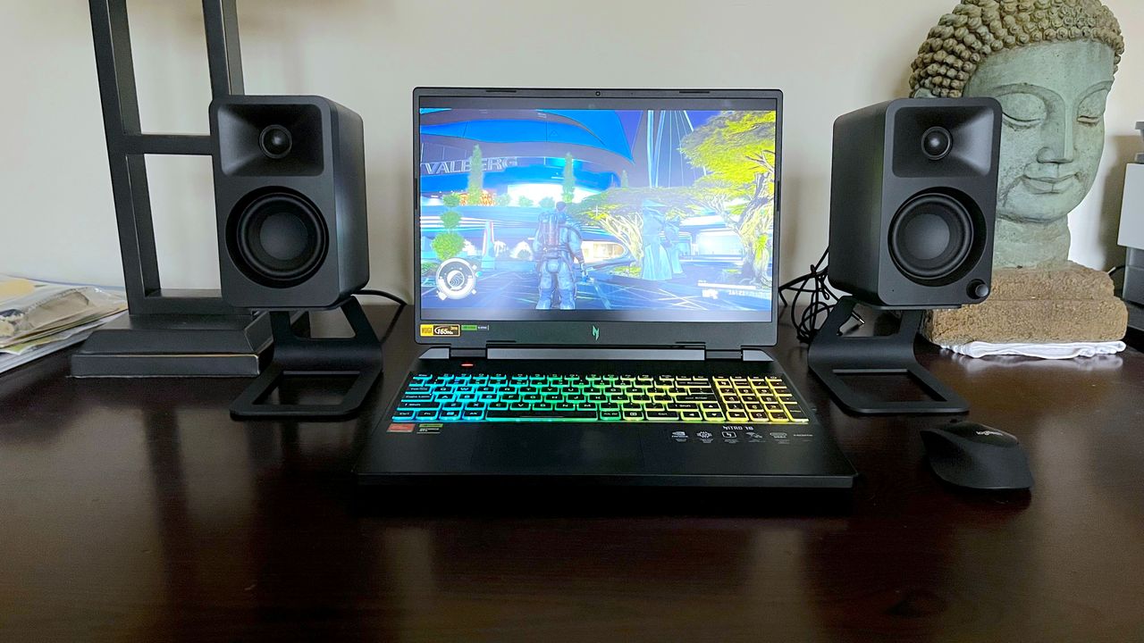 Acer Nitro 16 AMD on a desk playing a PC game