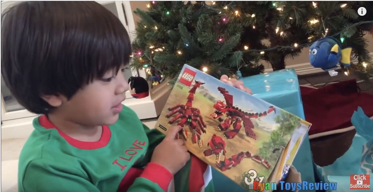 Ryan of Ryan ToysReview opens a Lego box.