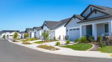 A stock photo of houses in a suburban neighborhood. 