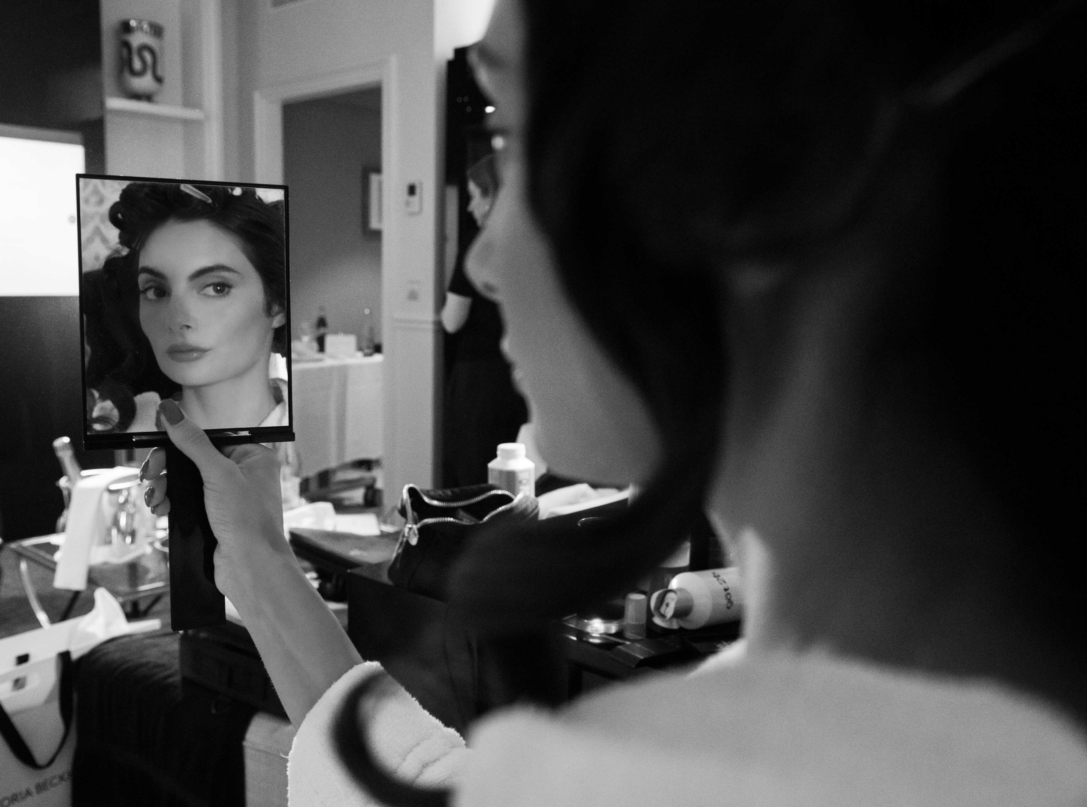 Paige DeSorbo gets ready for the Victoria Beckham Spring 2026 show during Paris Fashion Week wearing a gray suit set