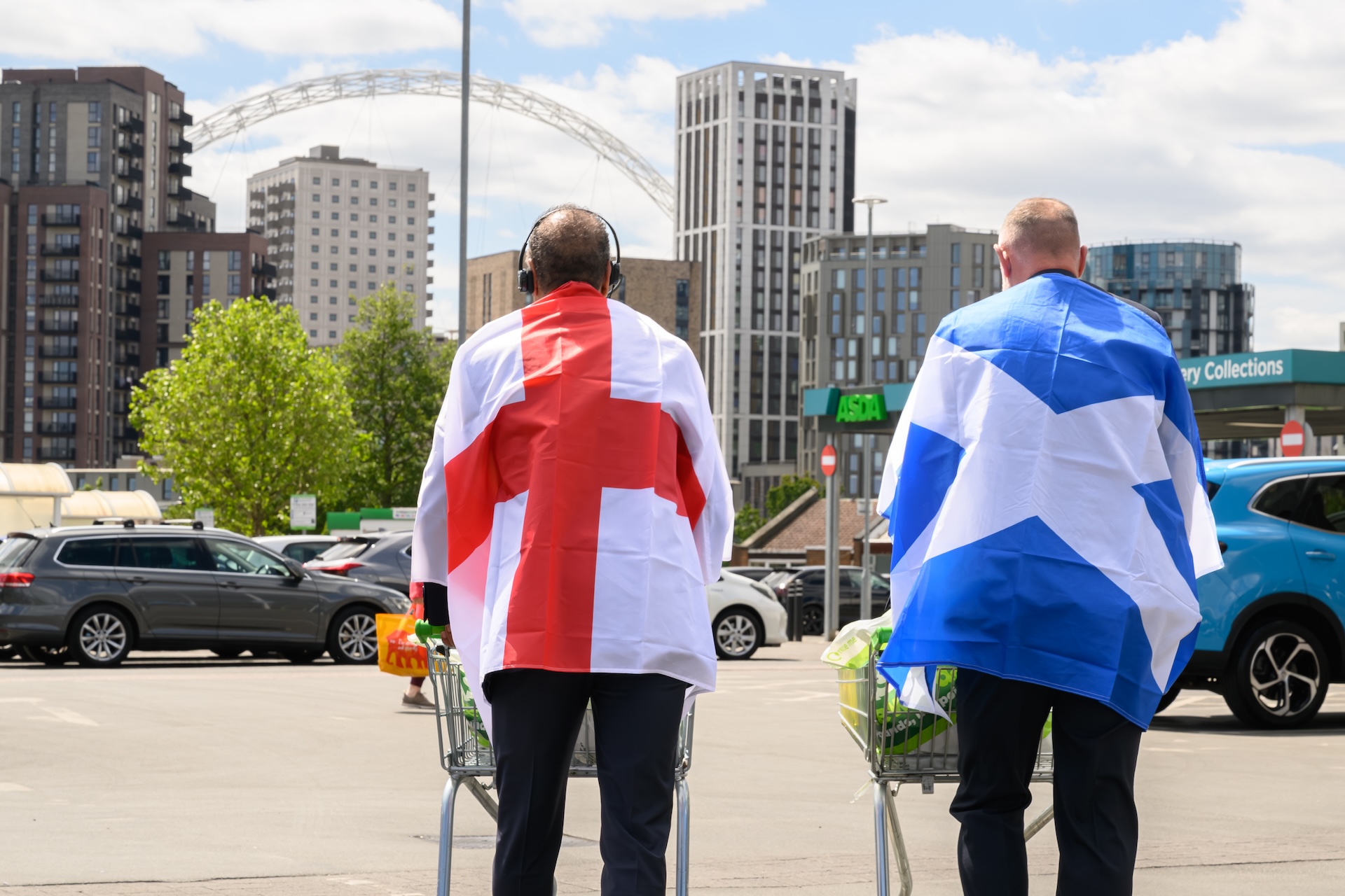 Chris Kamara and Kris Boyd looking at Wembley ahead of the World Cup with flags on their back