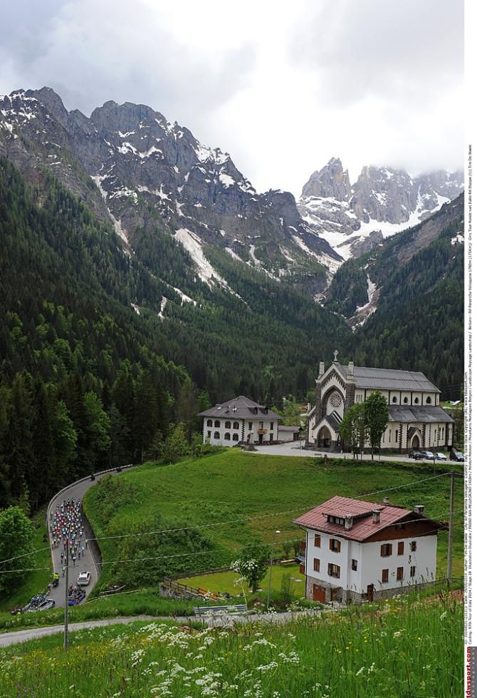 The peloton winds its way through small villages on the way to the final climb