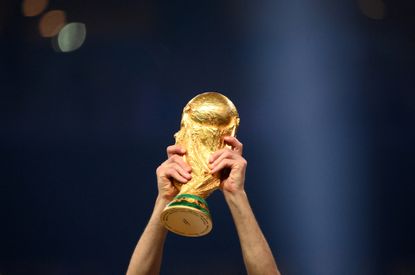 hands holding the world cup trophy