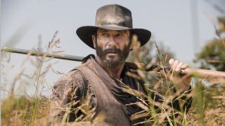 James Dutton walking through tall grass on 1883