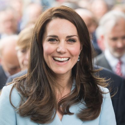 Kate Middleton smiling in blue suit