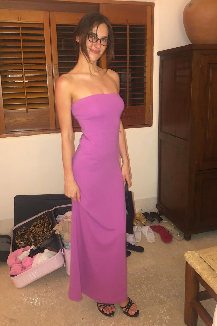 a woman wearing a pink stapless dress