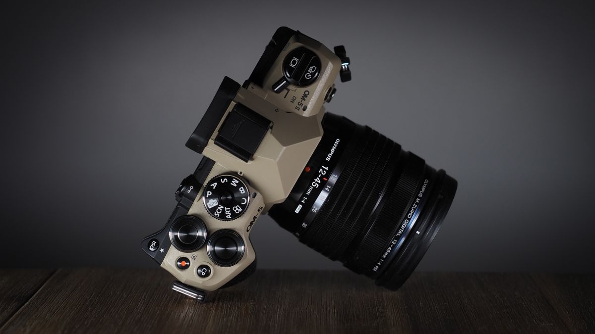 OM System OM-5 Mark II on a wooden surface with an Olympus M.Zuiko 12-45mm lens